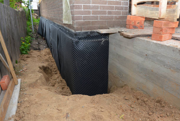 Happy homeowners after waterproofing job in Baltimore
